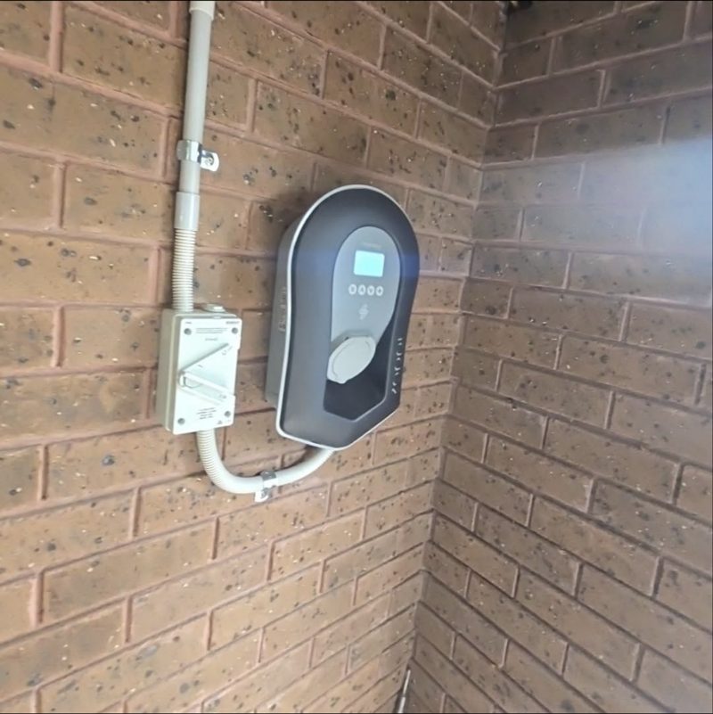myenergi Zappi charger installed on a brick wall